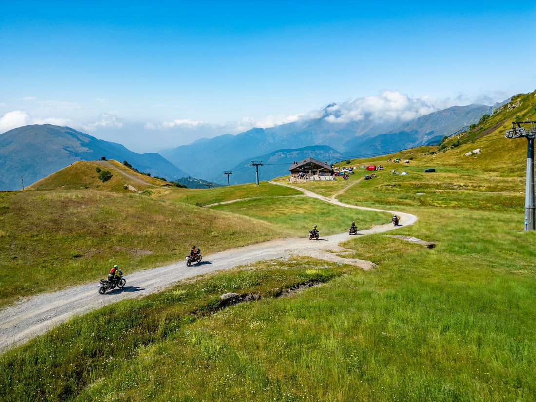 Aerial view of a historic stone fortress and winding alpine mountain roads blog cover