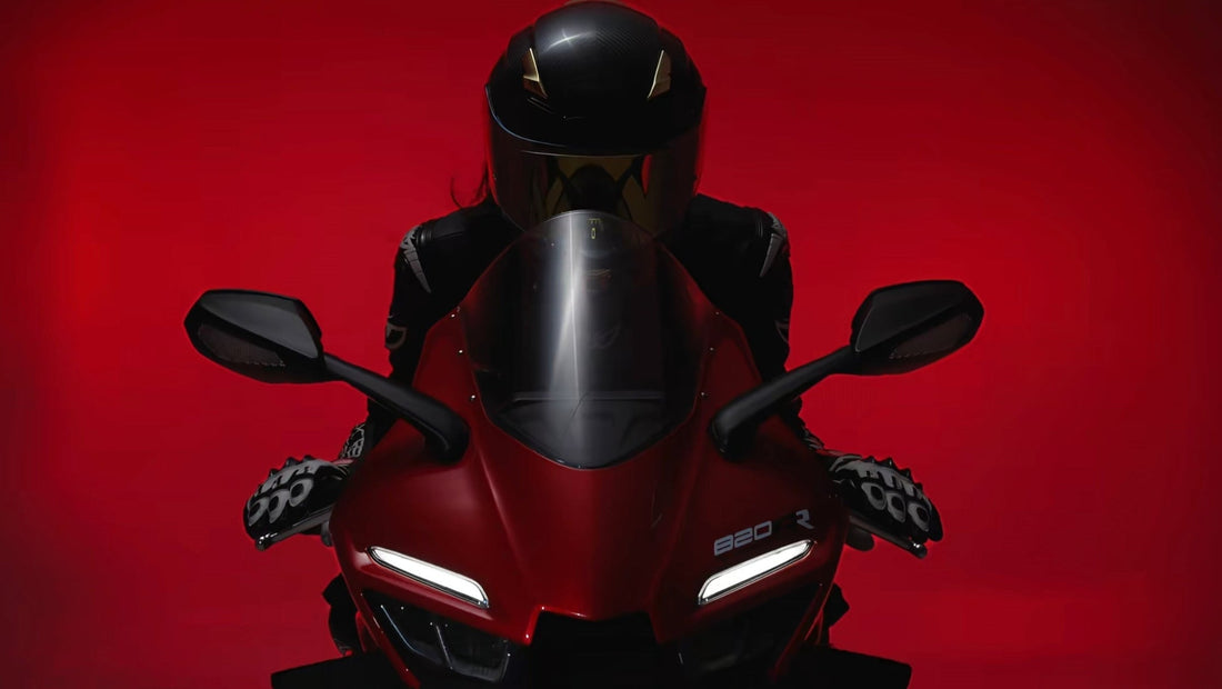 Motorcycle rider in black helmet on red sportbike front view blog cover