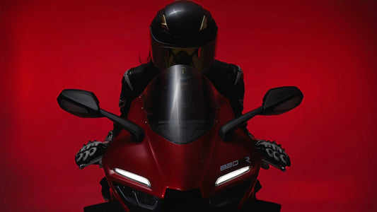 Motorcycle rider in black helmet on red sportbike front view blog cover