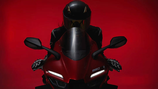 Motorcycle rider in black helmet on red sportbike front view blog cover